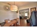 View of a dining area with a wooden table, chandelier, and an open doorway to the living room at 224 Raymond Ave, Frostproof, FL 33843