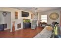 Comfortable living room with wood floors, entertainment center, and relaxing seating at 224 Raymond Ave, Frostproof, FL 33843