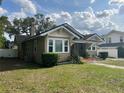 View of home's exterior with charming architecture, a well-maintained lawn, and vibrant plants enhancing its curb appeal at 236 E Seminole Ave, Lake Wales, FL 33853