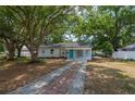 Charming single-story home featuring a well-manicured lawn and inviting curb appeal with mature trees at 315 Eastway Dr, Lakeland, FL 33803