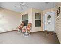 Relaxing front porch with two chairs, perfect for enjoying the outdoors with a ceiling fan at 3341 Highland Fairways Blvd, Lakeland, FL 33810