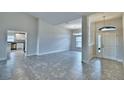 Bright, open-concept living space with tile flooring, neutral colors, and view into kitchen at 4023 Tullamore Ln, Auburndale, FL 33823