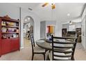Dining area with a round table and chairs adjacent to a reading room and kitchen area at 4041 Byrds Crossing Dr, Lakeland, FL 33812