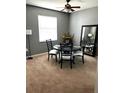 Dining room with a round table set, with a large mirror and window, ideal for intimate gatherings at 4041 Byrds Crossing Dr, Lakeland, FL 33812