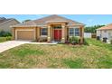 Charming single-story home with a well-maintained lawn, attached garage, and vibrant red front door at 4041 Byrds Crossing Dr, Lakeland, FL 33812