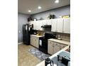 Efficient kitchen features matching appliances, tile backsplash, and ample counter space at 4041 Byrds Crossing Dr, Lakeland, FL 33812