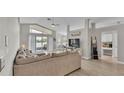 Open concept living space with a large sofa, vaulted ceilings, and a view into the dining area at 412 Emerald Cove Loop, Lakeland, FL 33813
