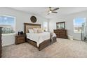 Spacious main bedroom with a ceiling fan, large bed, and natural light at 4122 Conjunction Way, Apopka, FL 32712