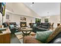 Comfortable living room with a fireplace, leather sofas, and a view to the outdoor area at 432 Sandestin Dr, Winter Haven, FL 33884