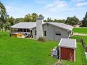 Rear view of the house showcasing a covered patio and hot tub, perfect for outdoor relaxation at 511 Hickory Hammock Rd, Lake Wales, FL 33859