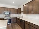 Modern kitchen featuring stainless steel appliances, sleek countertops and wood cabinets at 5776 Freshwater Canyon Dr, St Cloud, FL 34771