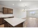 Bright open floor plan with a center island, wood flooring and recessed lighting at 5776 Freshwater Canyon Dr, St Cloud, FL 34771