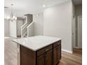 Bright open floor plan with a center island, wood flooring and staircase at 5776 Freshwater Canyon Dr, St Cloud, FL 34771