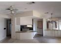 Open-concept living area boasts neutral colors and ample natural light, leading into the kitchen at 612 Forest Lake Dr, Lakeland, FL 33809