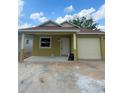 Charming one story home with front porch, vinyl siding and attached one car garage at 625 W 9Th St, Lakeland, FL 33805