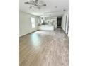 Open-concept living room, kitchen, and dining area featuring vinyl flooring and recessed lighting at 625 W 9Th St, Lakeland, FL 33805