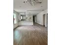 Open-concept living room, kitchen, and dining area featuring vinyl flooring and recessed lighting at 625 W 9Th St, Lakeland, FL 33805