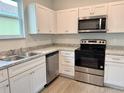 Modern kitchen featuring white cabinets, stainless steel appliances, and ample counter space at 629 W 9Th, Lakeland, FL 33805