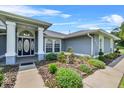 Inviting front entrance with a stylish door and lush, well-maintained landscaping at 647 Hart Lake Dr, Winter Haven, FL 33884