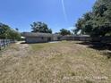 Large, unfenced backyard with a concrete patio, providing ample space for outdoor activities and landscaping at 6610 Chippendale Rd, Lakeland, FL 33809
