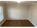 Cozy bedroom with warm wood floors, neutral walls, and a window providing natural light and view at 676 Jessanda Cir, Lakeland, FL 33813