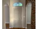 Inviting foyer with wood floors and arched doorways adding architectural interest to the home's design at 676 Jessanda Cir, Lakeland, FL 33813