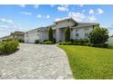 Charming single-story home featuring a three-car garage, manicured lawn, and a stone-accented facade at 6777 Bentridge Dr, Lakeland, FL 33813