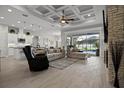 Bright living room with fireplace, pool views, modern decor, and an open floor plan at 6777 Bentridge Dr, Lakeland, FL 33813