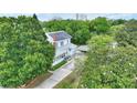 Aerial view of a two-story home with mature trees, a driveway, and a carport at 716 S Franklin Pl, Lakeland, FL 33815