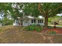 Charming single-story home with lush landscaping, manicured lawn, covered porch and a classic design at 716 S Franklin Pl, Lakeland, FL 33815