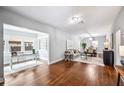 Bright living room with hardwood floors, neutral walls, and an adjacent office and dining area at 717 Frank Lloyd Wright Way, Lakeland, FL 33803