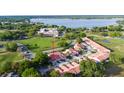 An aerial shot of villas with red tile roofs near a beautiful lake at 733 Carpenters Way # 36, Lakeland, FL 33809