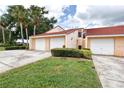 Well-maintained villa featuring two-car garage and lush landscaping, showcasing curb appeal and convenient parking at 733 Carpenters Way # 36, Lakeland, FL 33809