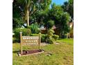 Community signage for Sandwedge Villas located at 733 Carpenters Way, surrounded by lush greenery at 733 Carpenters Way # 36, Lakeland, FL 33809