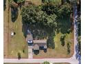 Aerial view of property featuring lush greenery, a house with a separate garage, and boundary lines at 7721 Forest Way, Lakeland, FL 33810