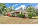 Well-maintained one story home with mature trees and inviting curb appeal at 7741 Merrily Way, Lakeland, FL 33809
