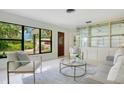 Bright and airy living room features large windows, stylish decor, and comfortable seating with modern accents at 865 E Mann Rd, Bartow, FL 33830