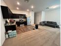 Open concept living area showcases a modern kitchen with stainless steel appliances and dark cabinetry at 879 Grandin St, Davenport, FL 33837