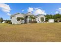 Charming home with large yard and well-manicured landscaping, with additional storage shed in back at 8909 N Campbell Rd, Lakeland, FL 33810