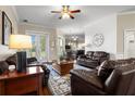 Comfortable living room with a ceiling fan, hardwood floors, and access to the backyard at 8909 N Campbell Rd, Lakeland, FL 33810