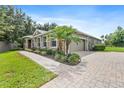 Attractive home featuring a brick driveway, well-maintained lawn, mature landscaping and a side entry garage at 1001 Lena Run Ct, Winter Haven, FL 33880