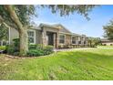 Charming single-story home with stone accents, mature tree and lush landscaping creating great curb appeal at 1001 Lena Run Ct, Winter Haven, FL 33880