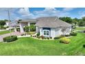 Inviting home with manicured lawn, shrubbery, and an attached porte cochere for convenient parking at 1056 Rally Dr, Polk City, FL 33868