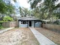 Charming single-story home with fenced in yard, wood pergola, and easy to maintain landscaping at 1160 Austin St, Bartow, FL 33830