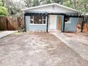 Charming single-story home featuring a black pergola and inviting front entrance in a tree-filled yard at 1160 Austin St, Bartow, FL 33830