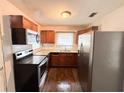 Well-lit kitchen featuring stainless steel appliances, wooden cabinets, and marble-look counters at 1160 Austin St, Bartow, FL 33830