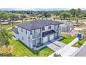 New modern construction home with a two-car garage, gray tones, and green lawn at 1171 Windjammer Dr, Lakeland, FL 33803