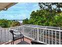 Balcony view with black furniture overlooking scenic lake at 1218 Lake Point Ter, Lakeland, FL 33813