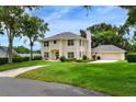 Charming two-story home with a well-maintained lawn, beautiful landscaping, and a spacious garage at 1218 Lake Point Ter, Lakeland, FL 33813