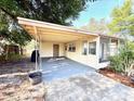 Large carport with ample parking space and room for outdoor seating and gatherings at 135 E Columbia St, Lake Alfred, FL 33850